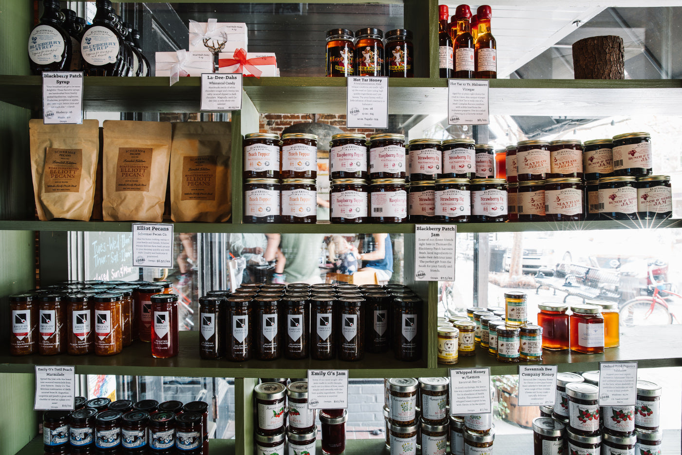 Some of the retail items offered at Sweet Grass Dairy Cheese Shop include jam, honey, and pecans. 