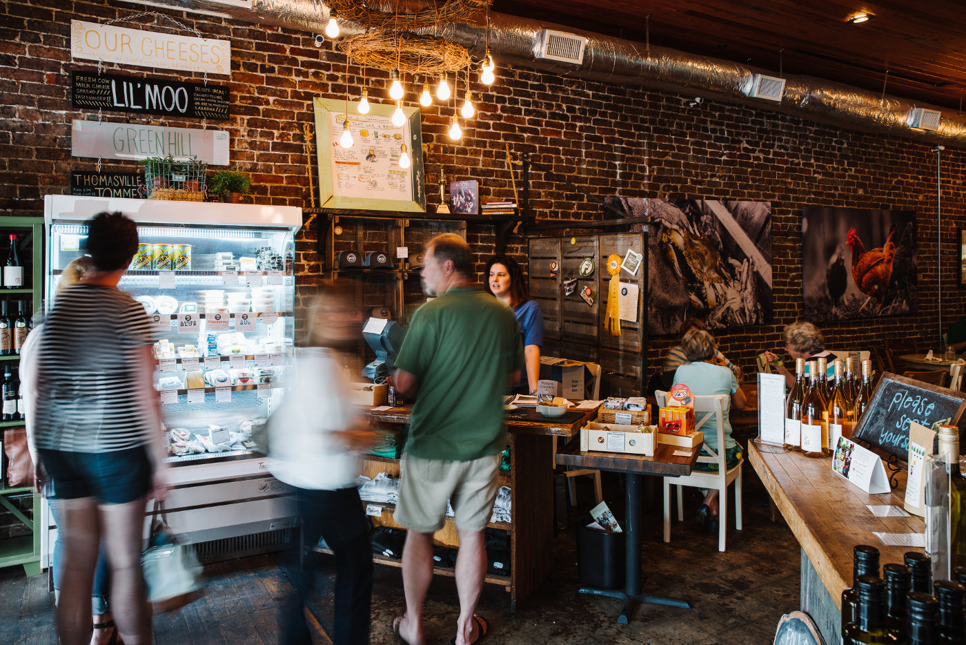 People purchasing items at the retail section of Sweet Grass Dairy Cheese Shop. 