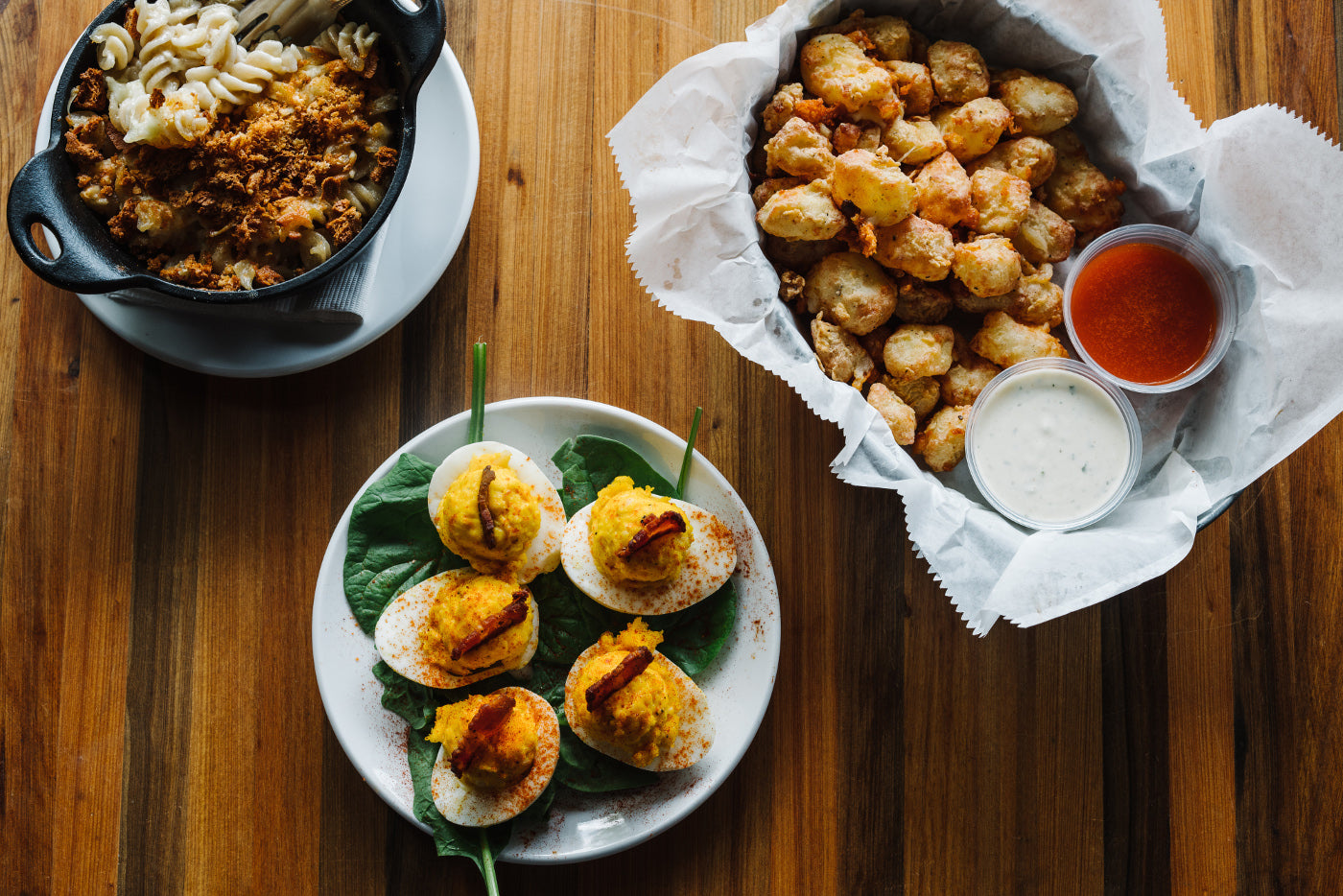 Mac & Cheese, Deviled Eggs, and Cheese Curds sitting on a table