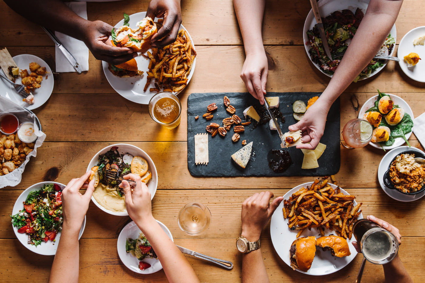 An overhead view of a table full of food and drinks at Sweet Grass Dairy Cheese Shop. 