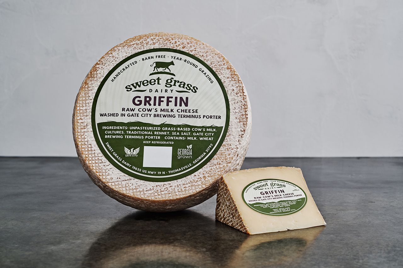 Sweet Grass Dairy's Griffin cheese that has been washed in Terminus Porter Beer positioned to show it's packaging. 