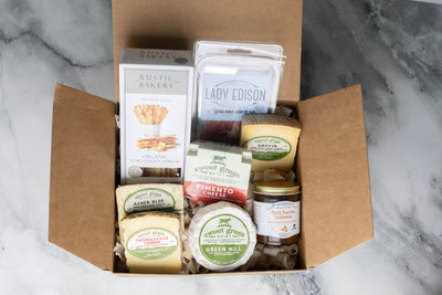 Cheese, Proscuitto, Jam, and Crackers in a gift box ready to be purchased.